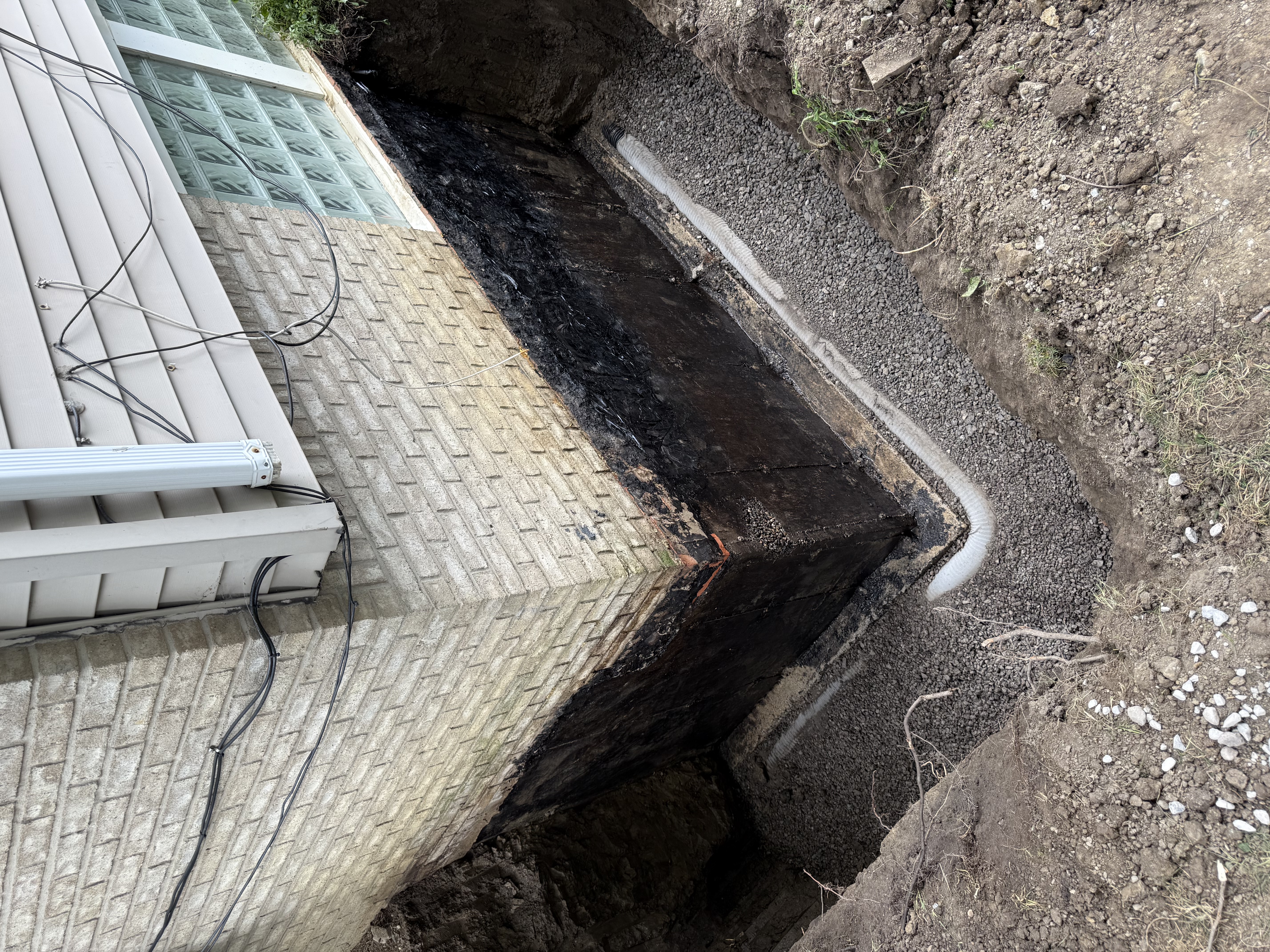 Exterior waterproofing with tar coating