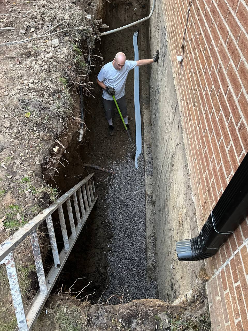 Applying waterproof membrane coating to foundation walls