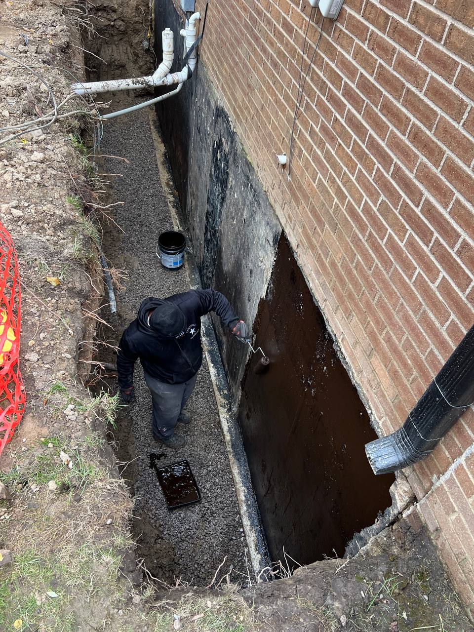 Excavation around foundation perimeter for waterproofing access
